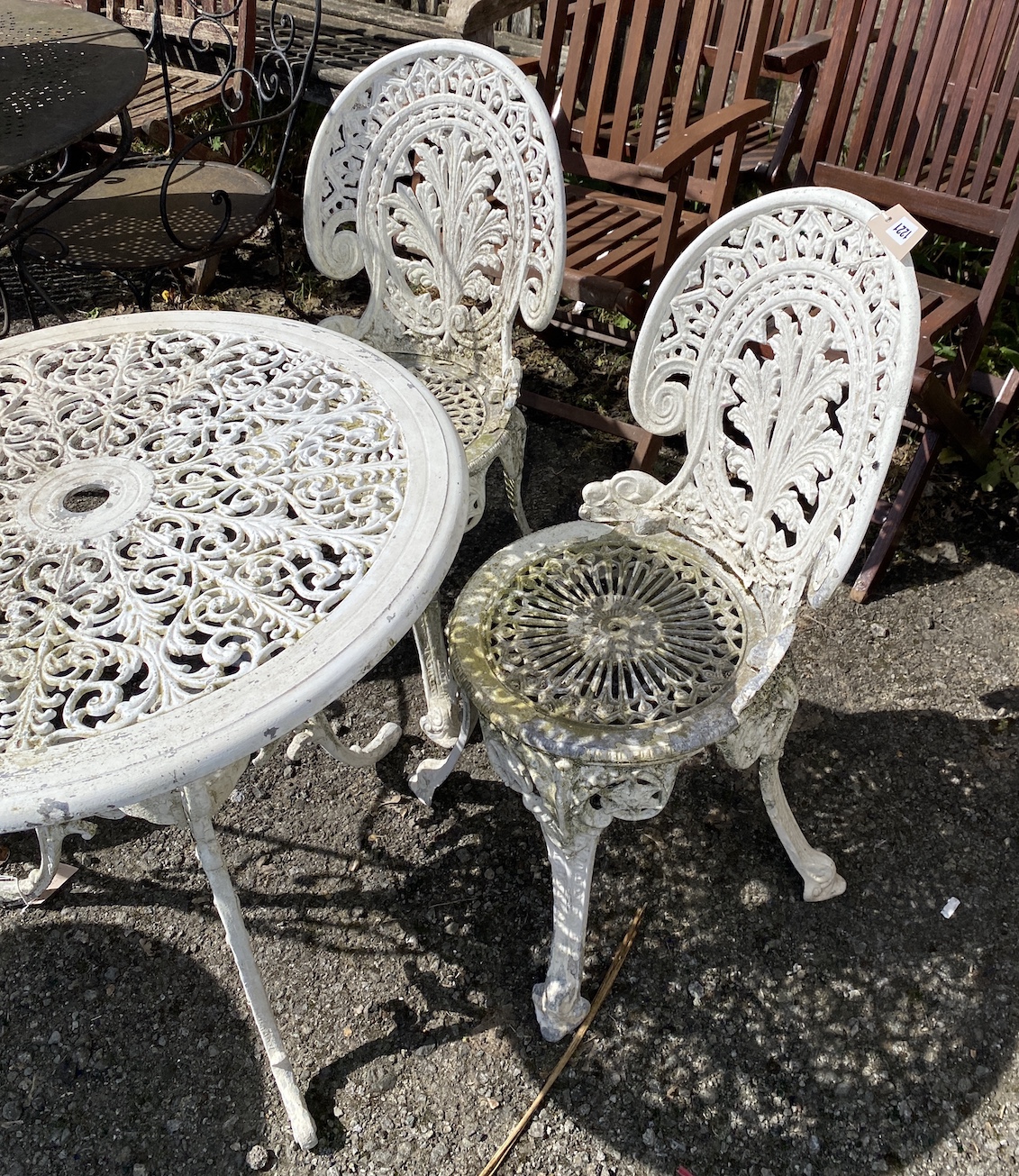 A Victorian style painted aluminium garden table, diameter 68cm, height 68cm, and a pair of chairs